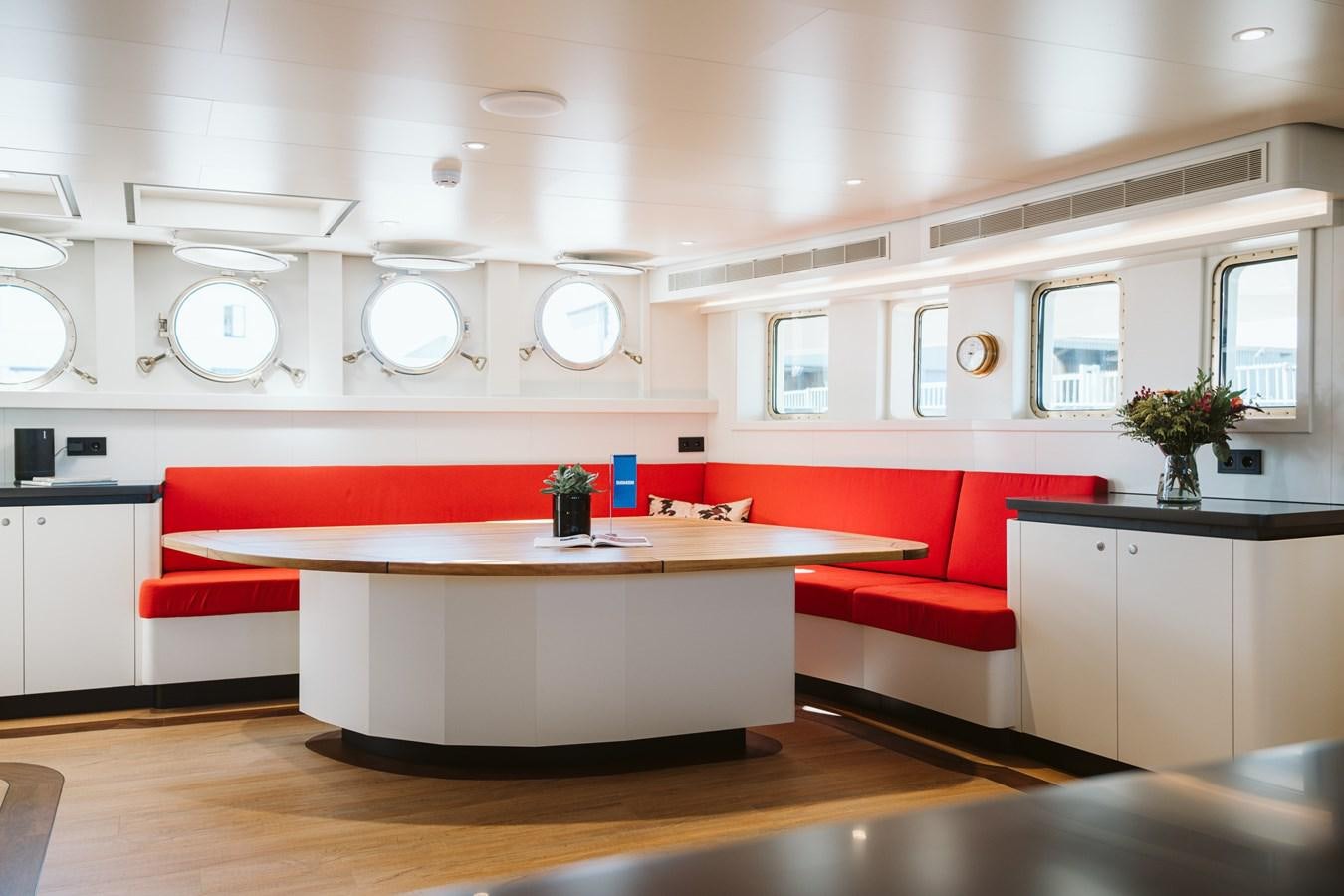 a kitchen with a red table aboard SCINTILLA MARIS Yacht for Sale