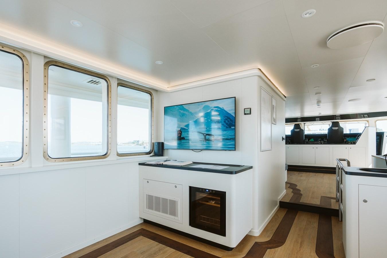 a kitchen with a stove and a fireplace aboard SCINTILLA MARIS Yacht for Sale