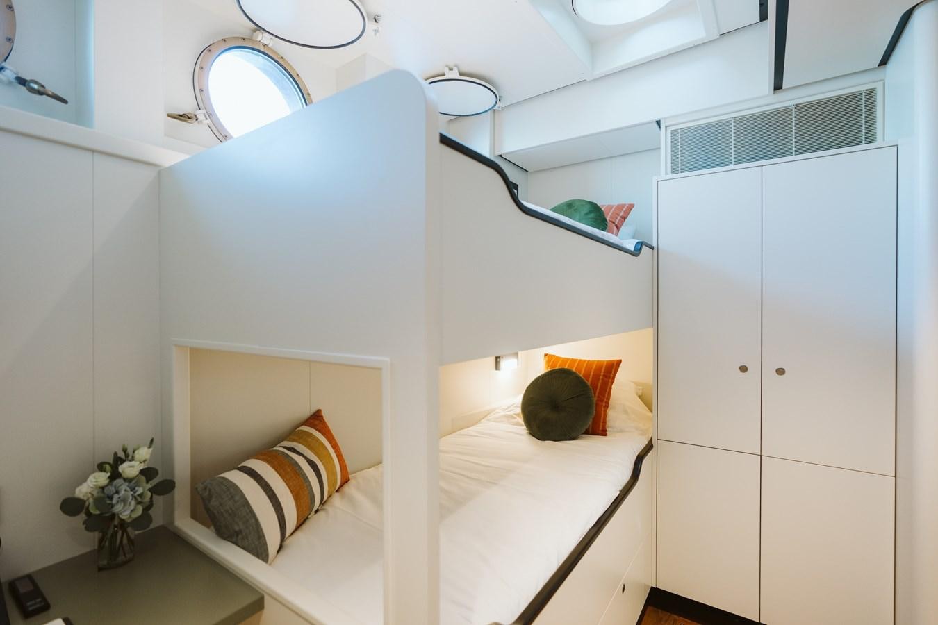 a white room with a white bed and a white wall aboard SCINTILLA MARIS Yacht for Sale