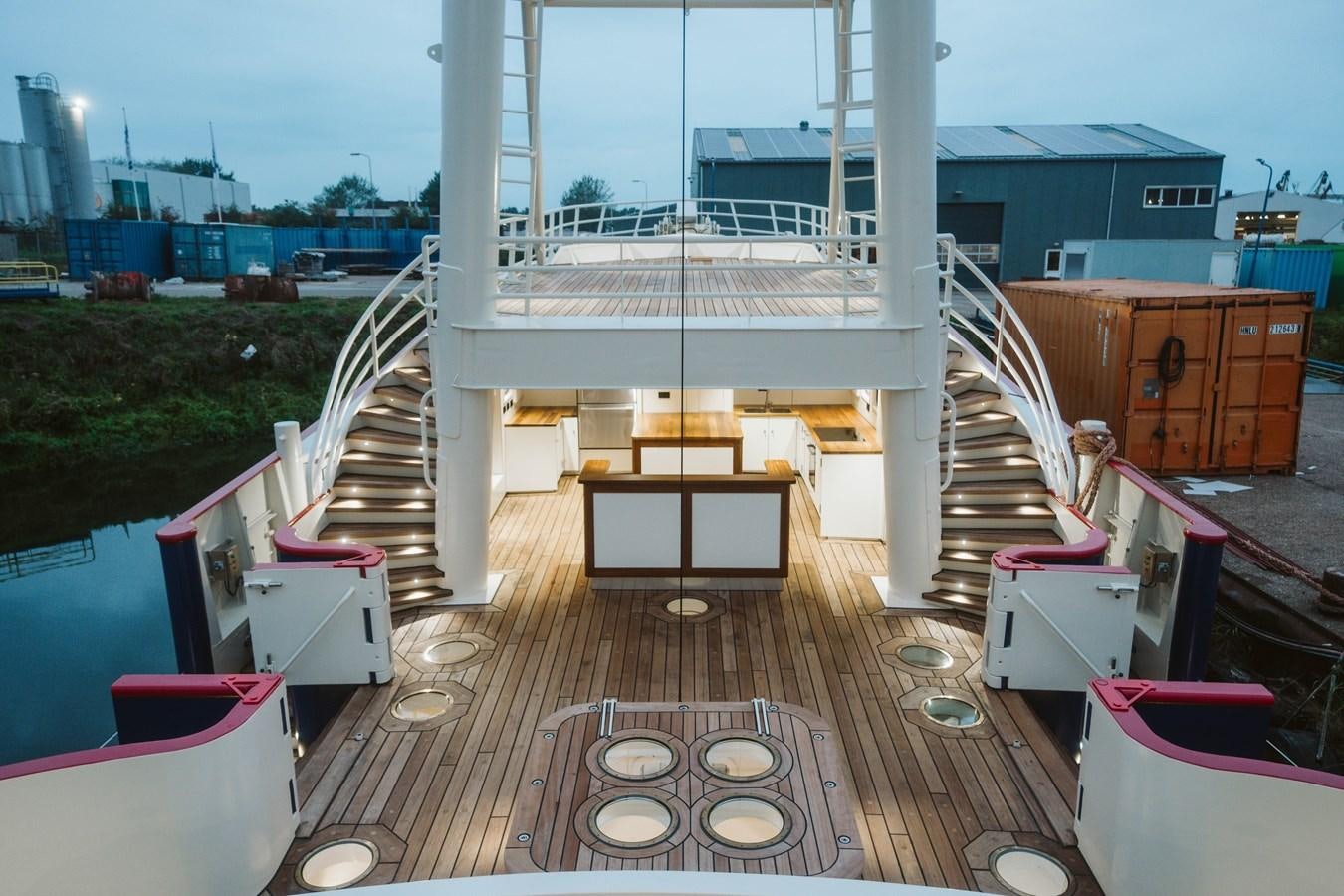 a deck with a pool and a deck with a deck and a city in the background aboard SCINTILLA MARIS Yacht for Sale