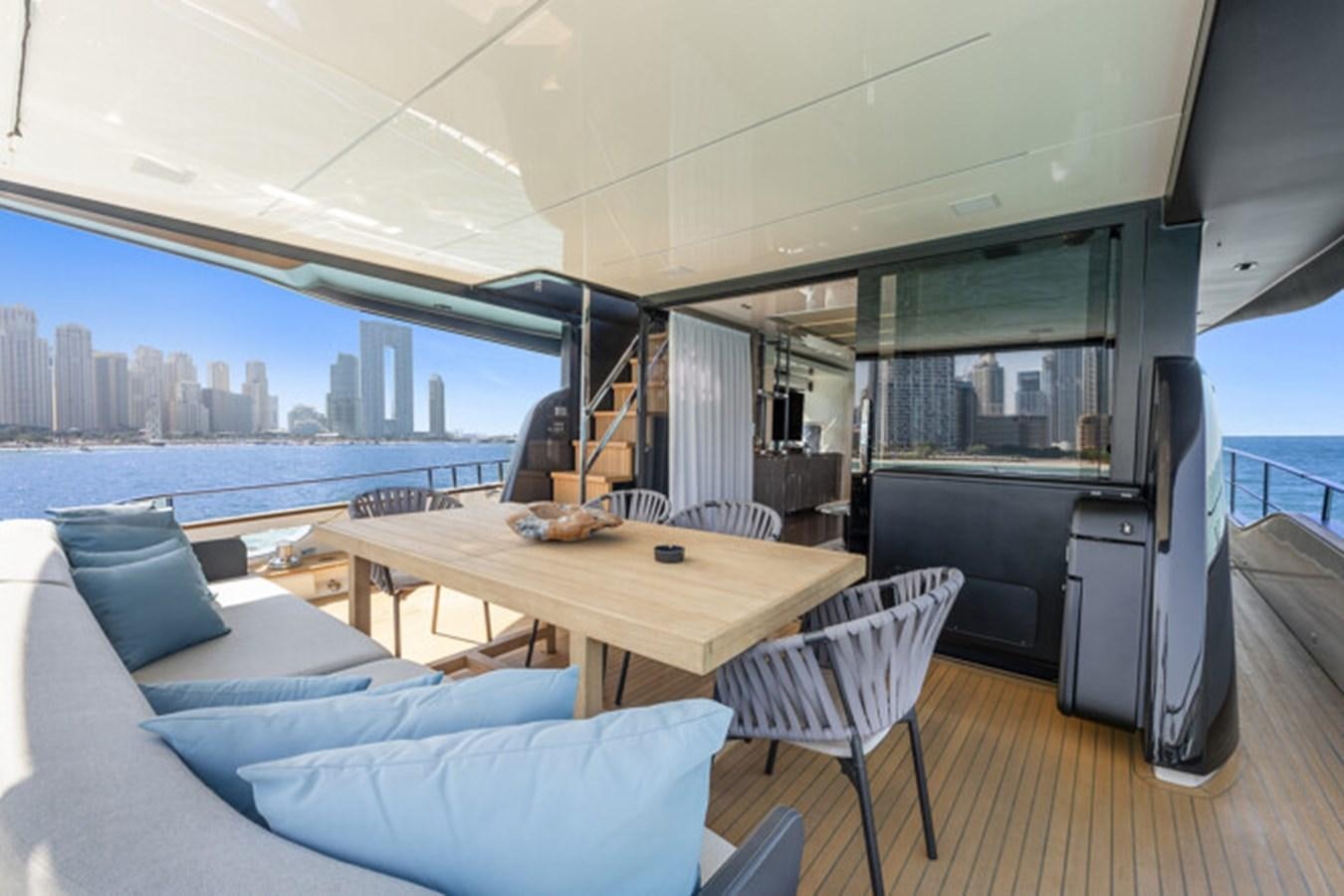 a large room with a table and a couch aboard MOSHE Yacht for Sale