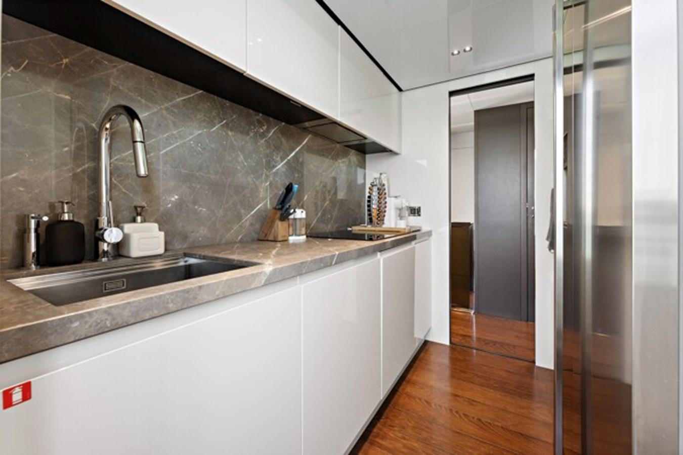 a kitchen with a sink and a large refrigerator aboard MOSHE Yacht for Sale