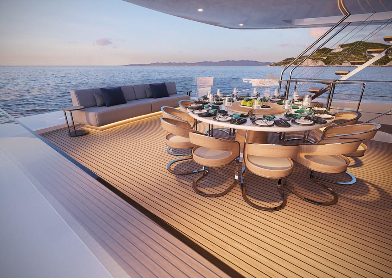 a deck with a table and chairs on it aboard VITRUVIUS Yacht for Sale