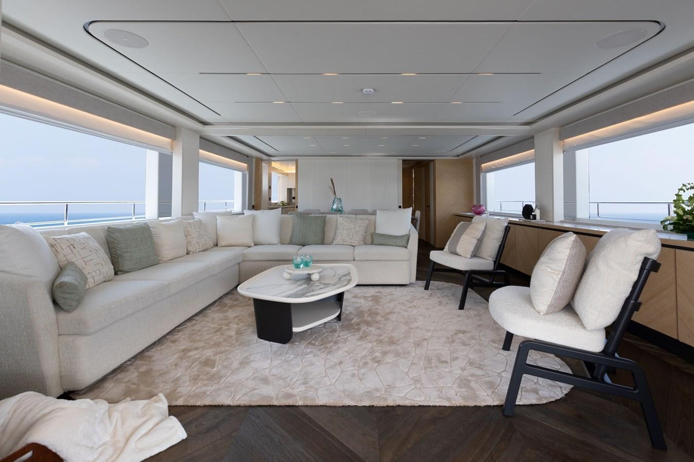 a living room with a couch and a table aboard #5 NOMAD 101 Yacht for Sale