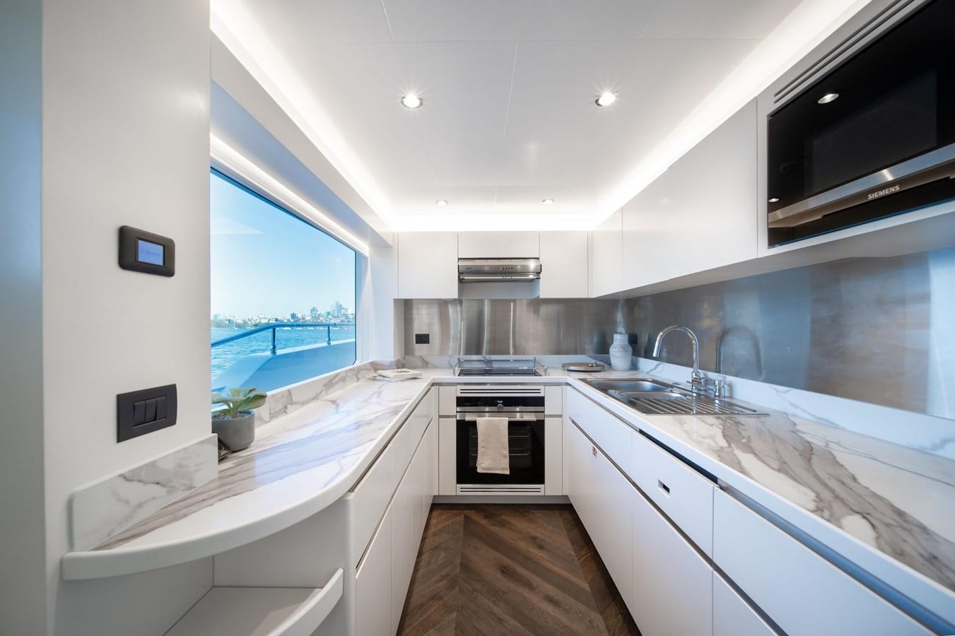 a kitchen with a large window aboard #5 NOMAD 101 Yacht for Sale
