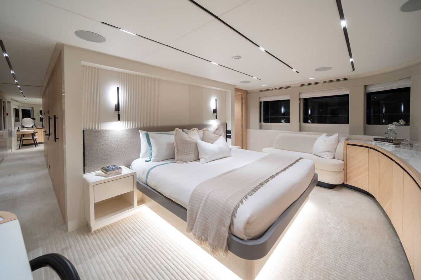 a room with a bed and a desk aboard #5 NOMAD 101 Yacht for Sale