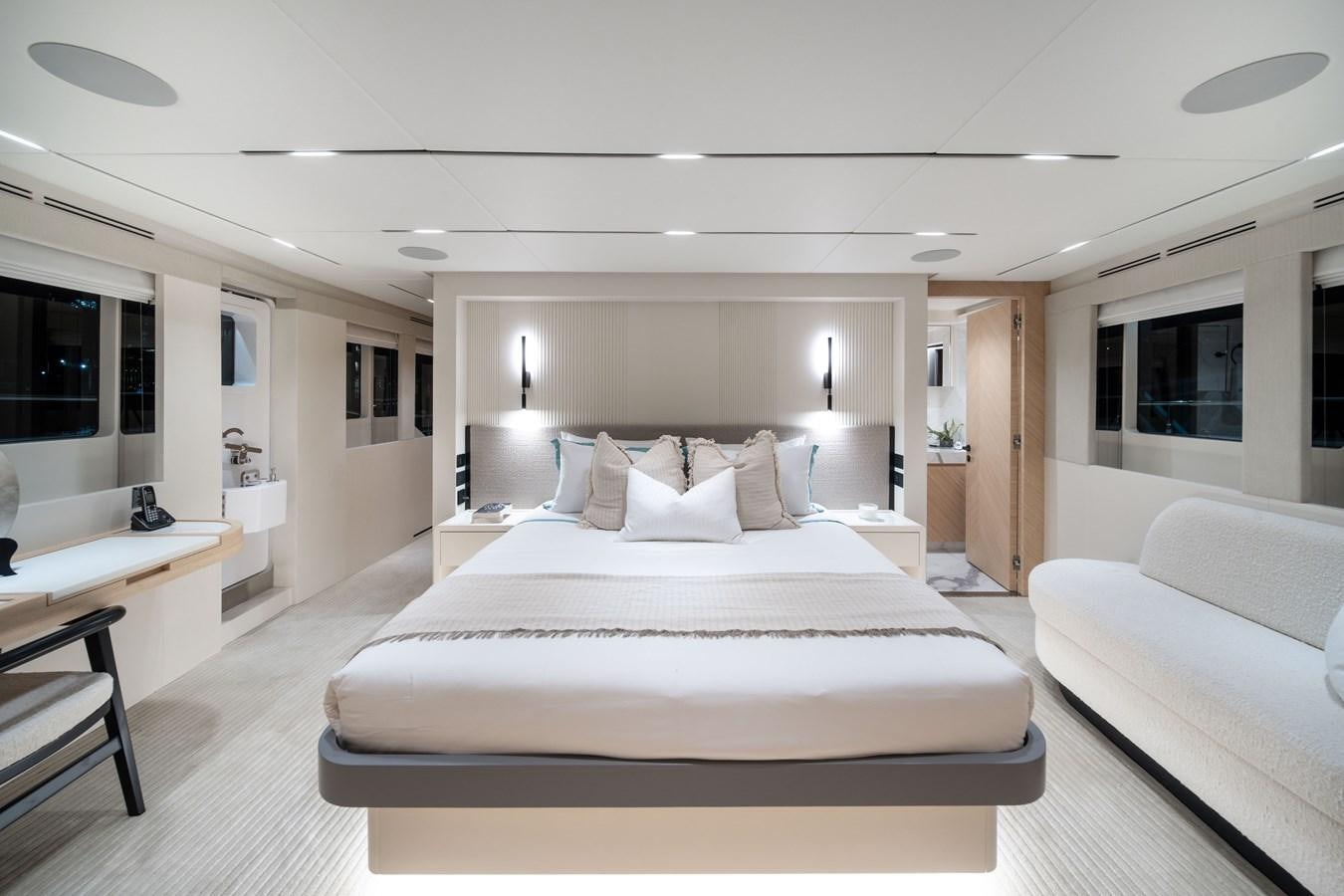 a large white bed in a room aboard #5 NOMAD 101 Yacht for Sale