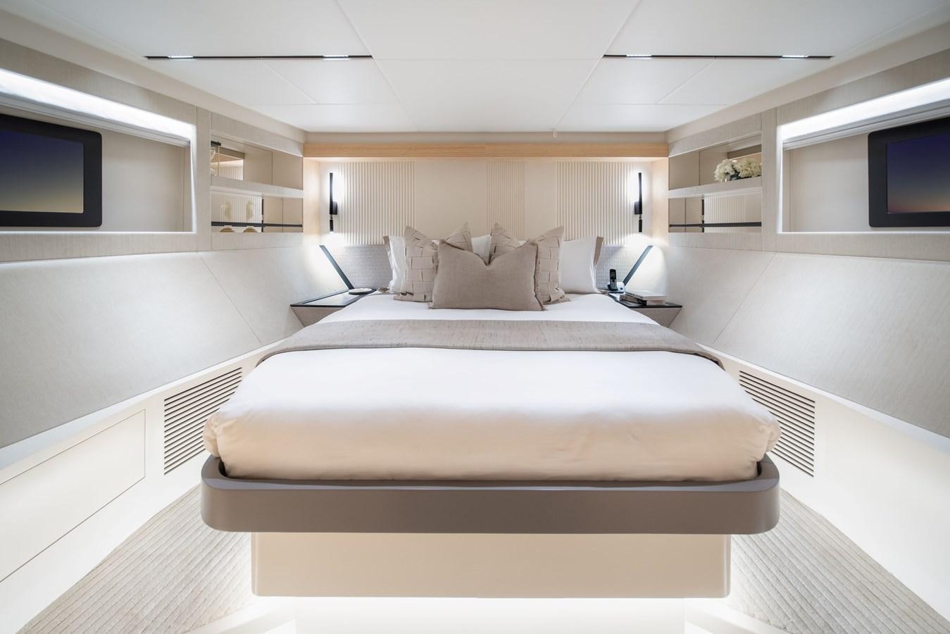 a large white bedroom with a large bed aboard #5 NOMAD 101 Yacht for Sale