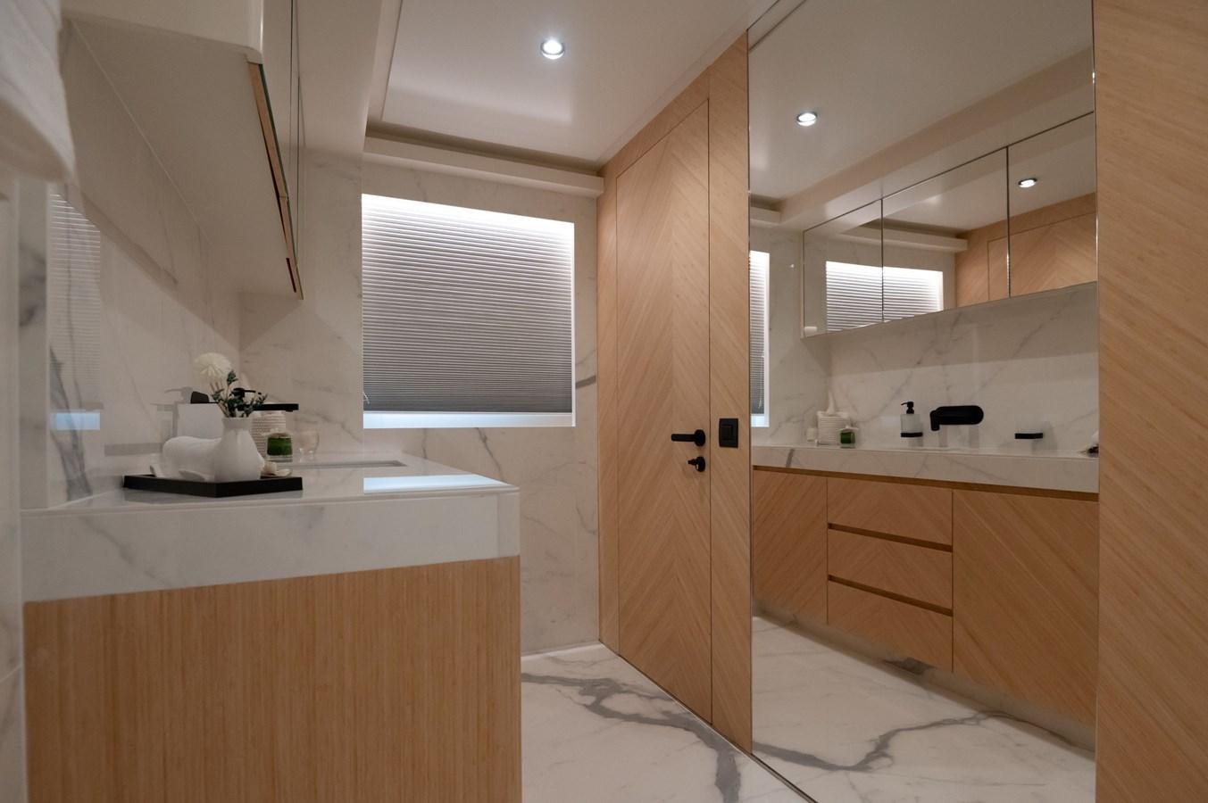 a kitchen with a wooden door aboard #5 NOMAD 101 Yacht for Sale