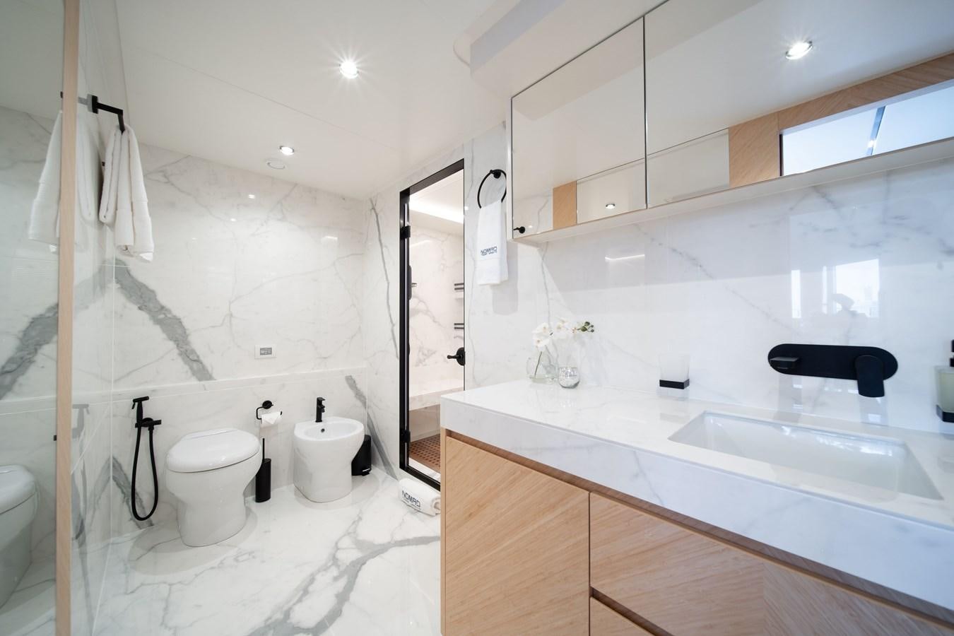 a bathroom with a sink toilet and bathtub aboard #5 NOMAD 101 Yacht for Sale