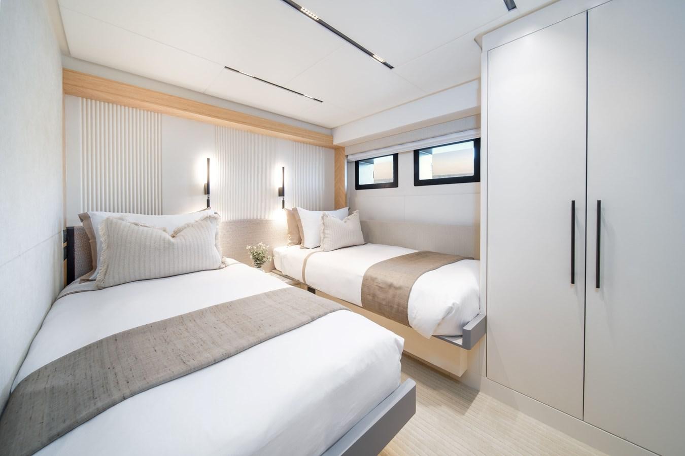 a room with two beds aboard #5 NOMAD 101 Yacht for Sale