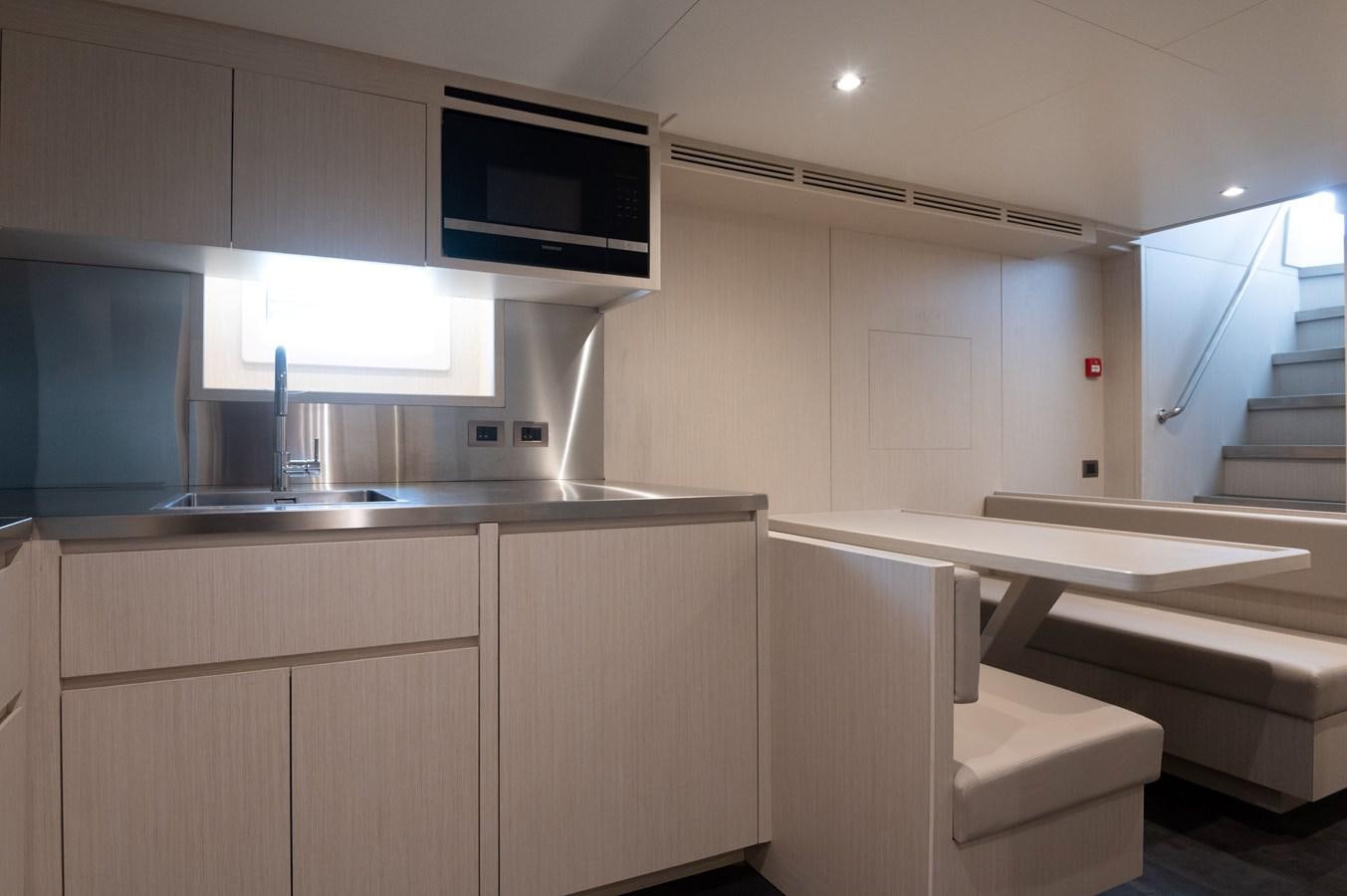 a kitchen with a microwave oven aboard #5 NOMAD 101 Yacht for Sale