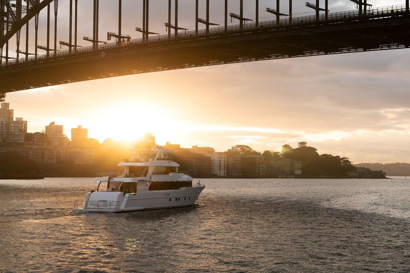 a boat sailing under a bridge aboard #5 NOMAD 101 Yacht for Sale