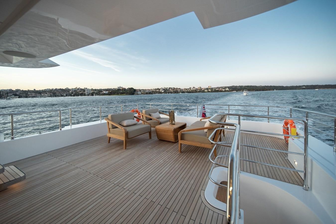 a deck with chairs and a body of water aboard #5 NOMAD 101 Yacht for Sale