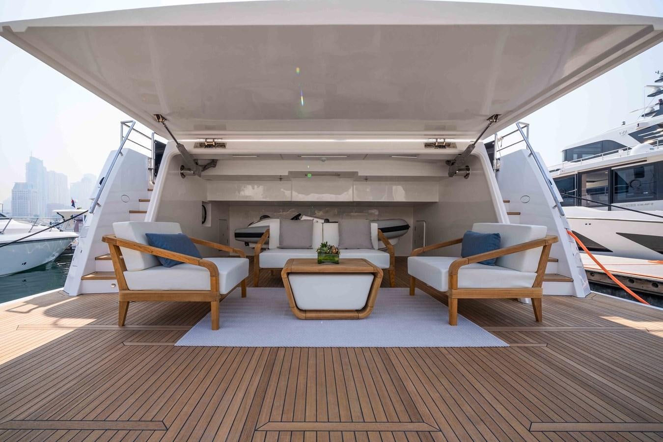 a room with a bench and a table aboard #5 NOMAD 101 Yacht for Sale