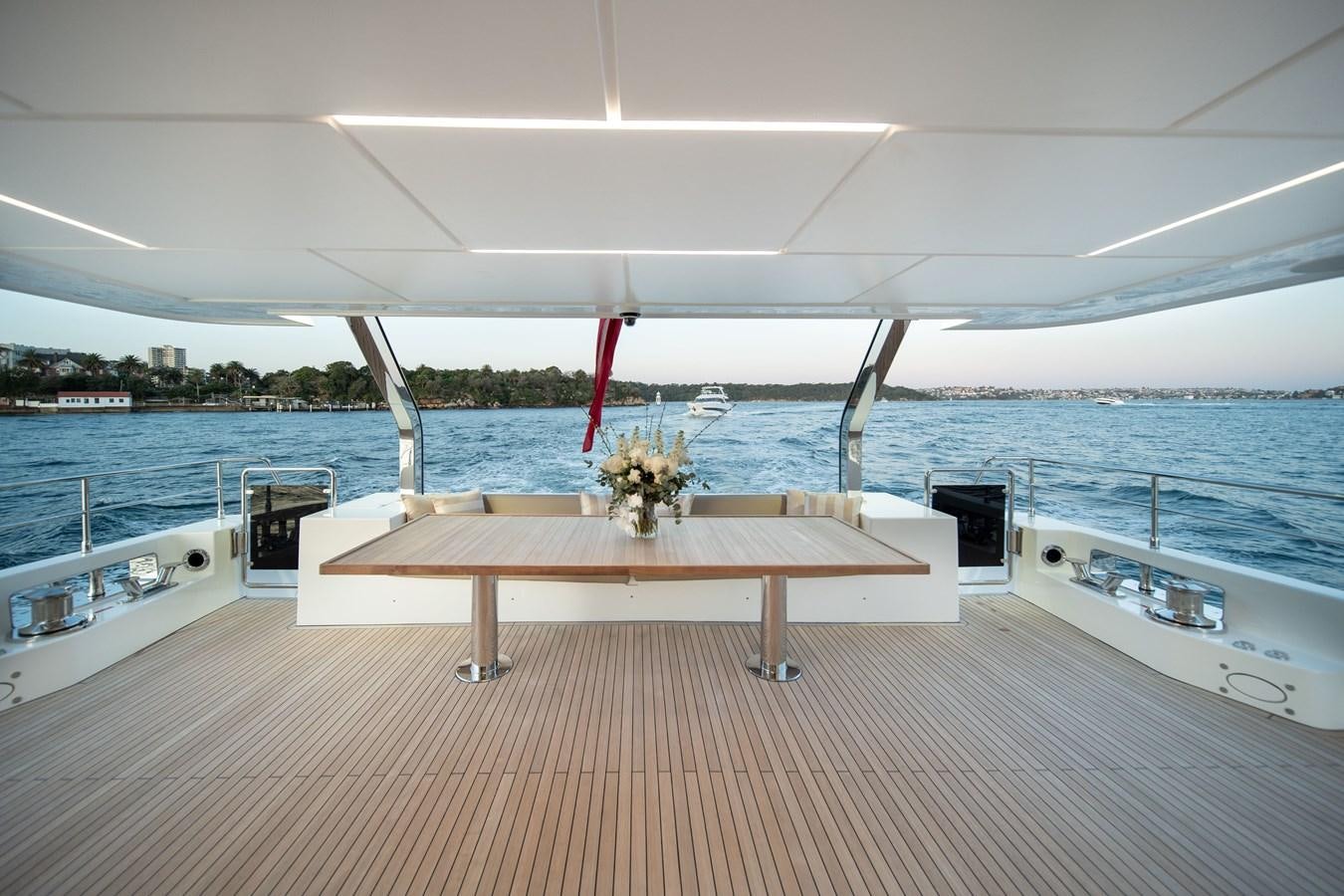 a table on a deck aboard #5 NOMAD 101 Yacht for Sale