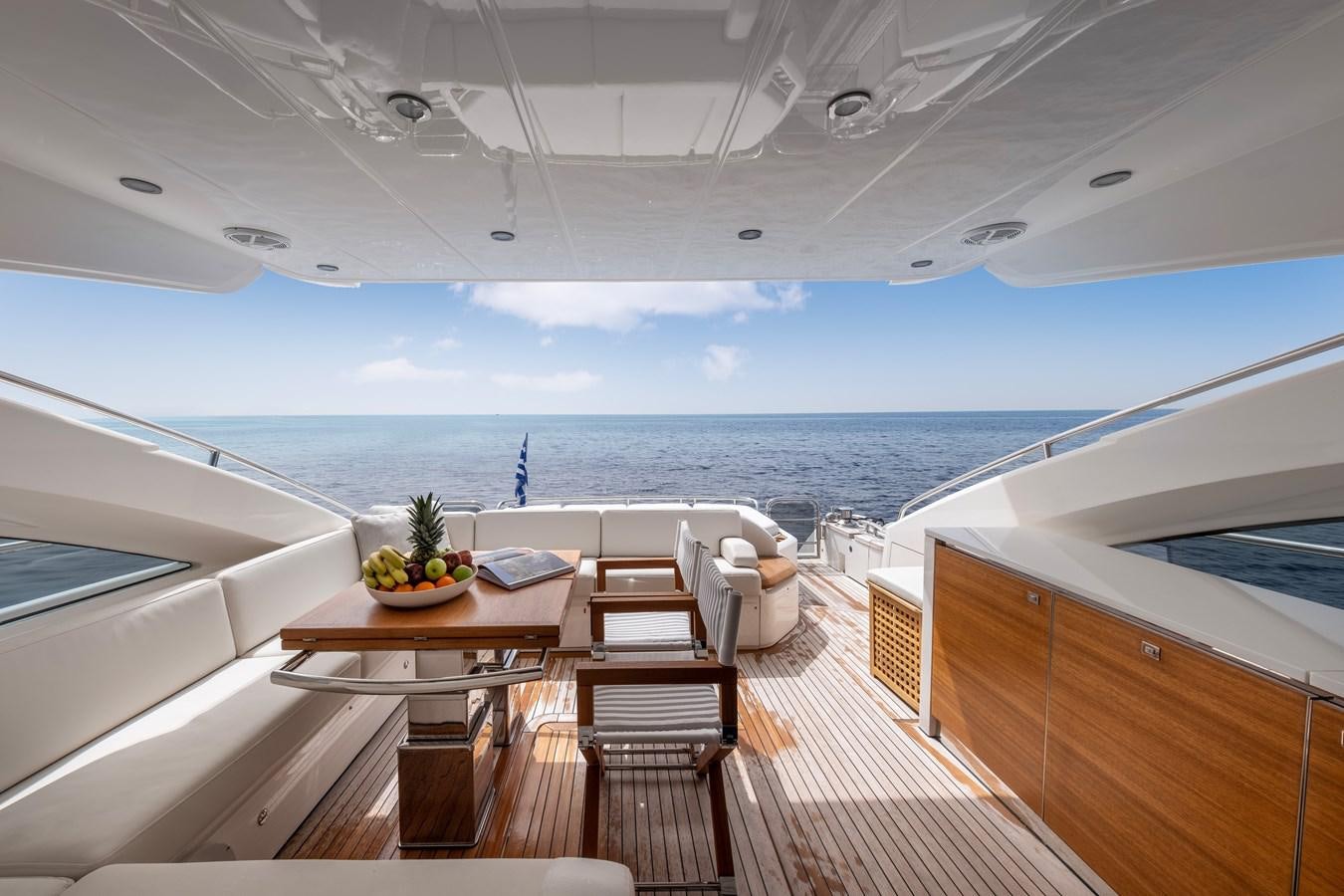 a room with a table chairs and a view of the ocean aboard WANDERER Yacht for Sale