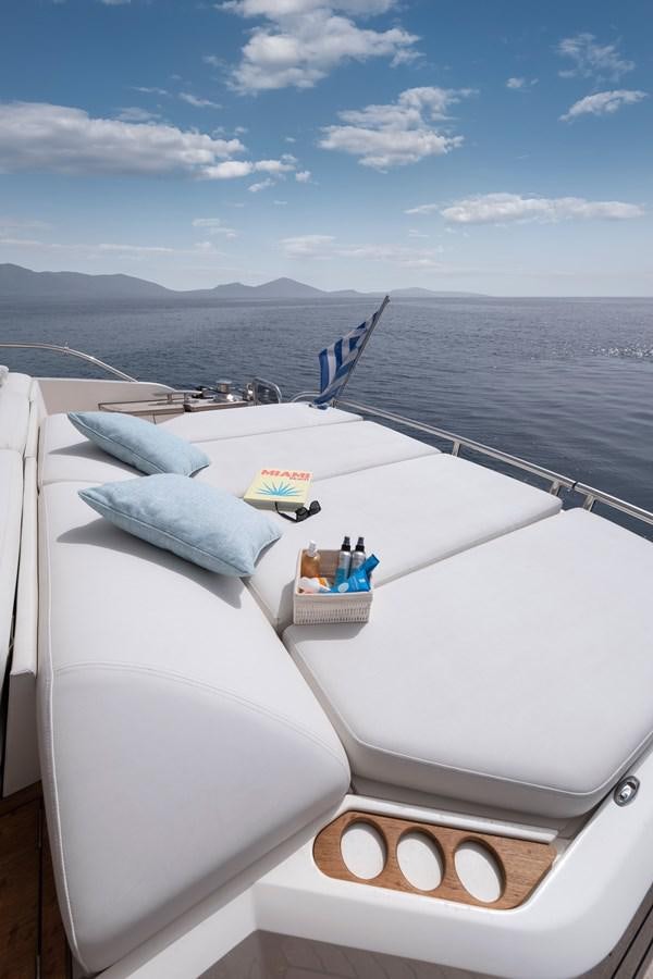 a bed with a white bed and a blue sky above aboard WANDERER Yacht for Sale