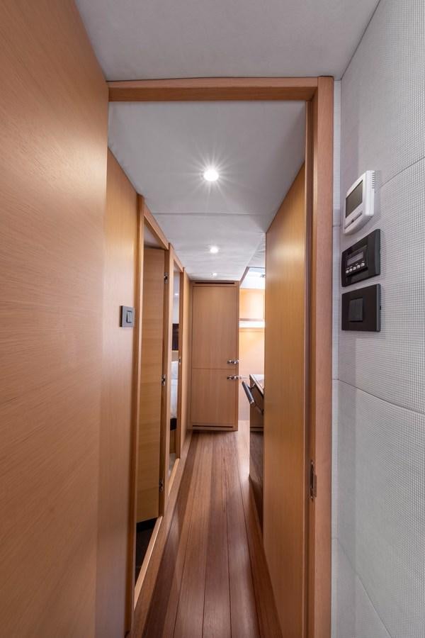 a hallway with a door and a light on the wall aboard WANDERER Yacht for Sale