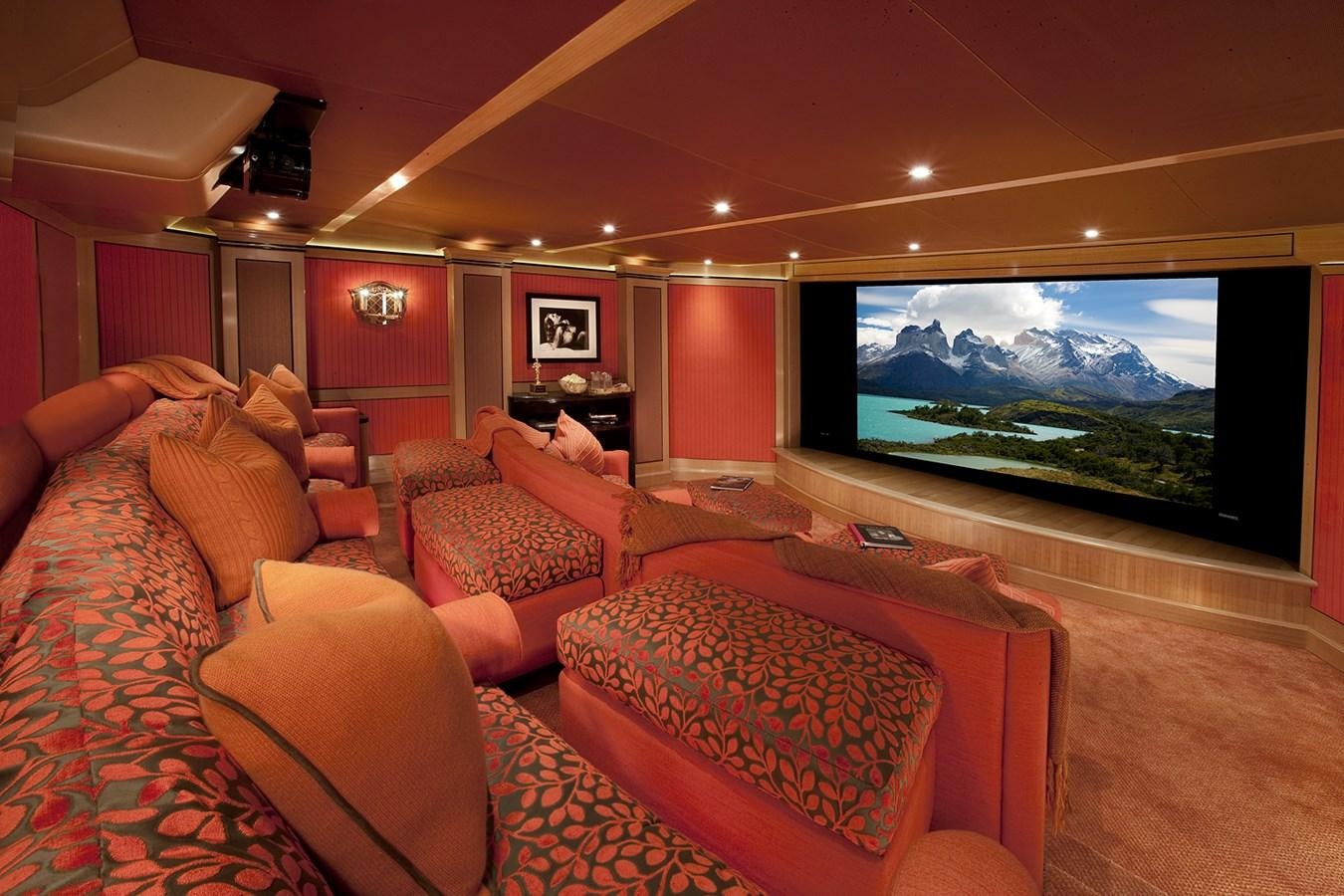 a living room with a large screen aboard ATTESSA IV Yacht for Sale