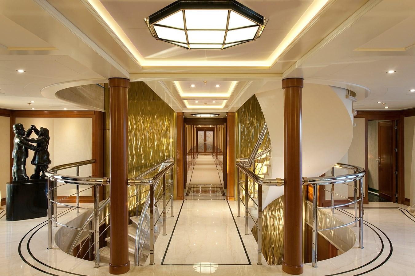 a large room with stairs and a chandelier aboard ATTESSA IV Yacht for Sale