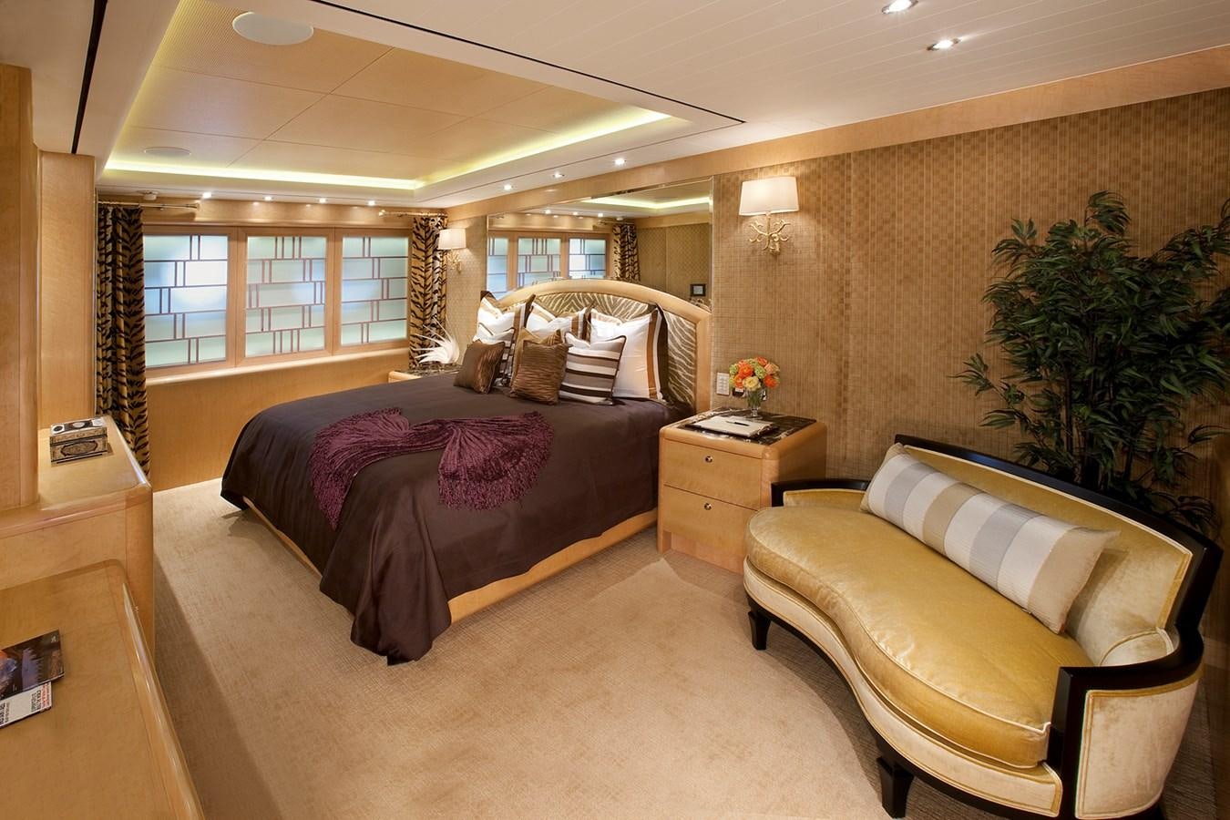a bedroom with a bed and a couch aboard ATTESSA IV Yacht for Sale