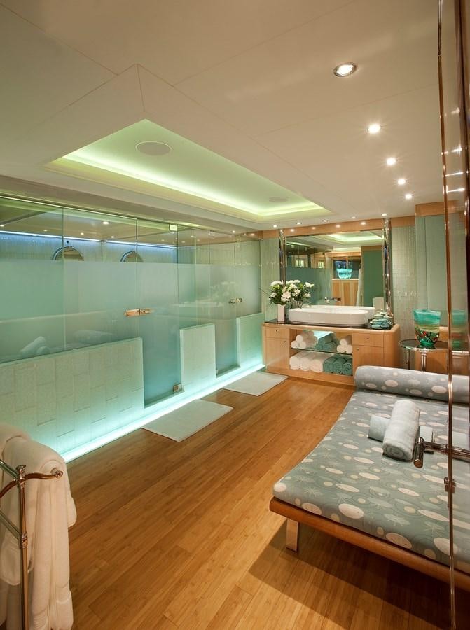 a room with a bed and a large mirror aboard ATTESSA IV Yacht for Sale