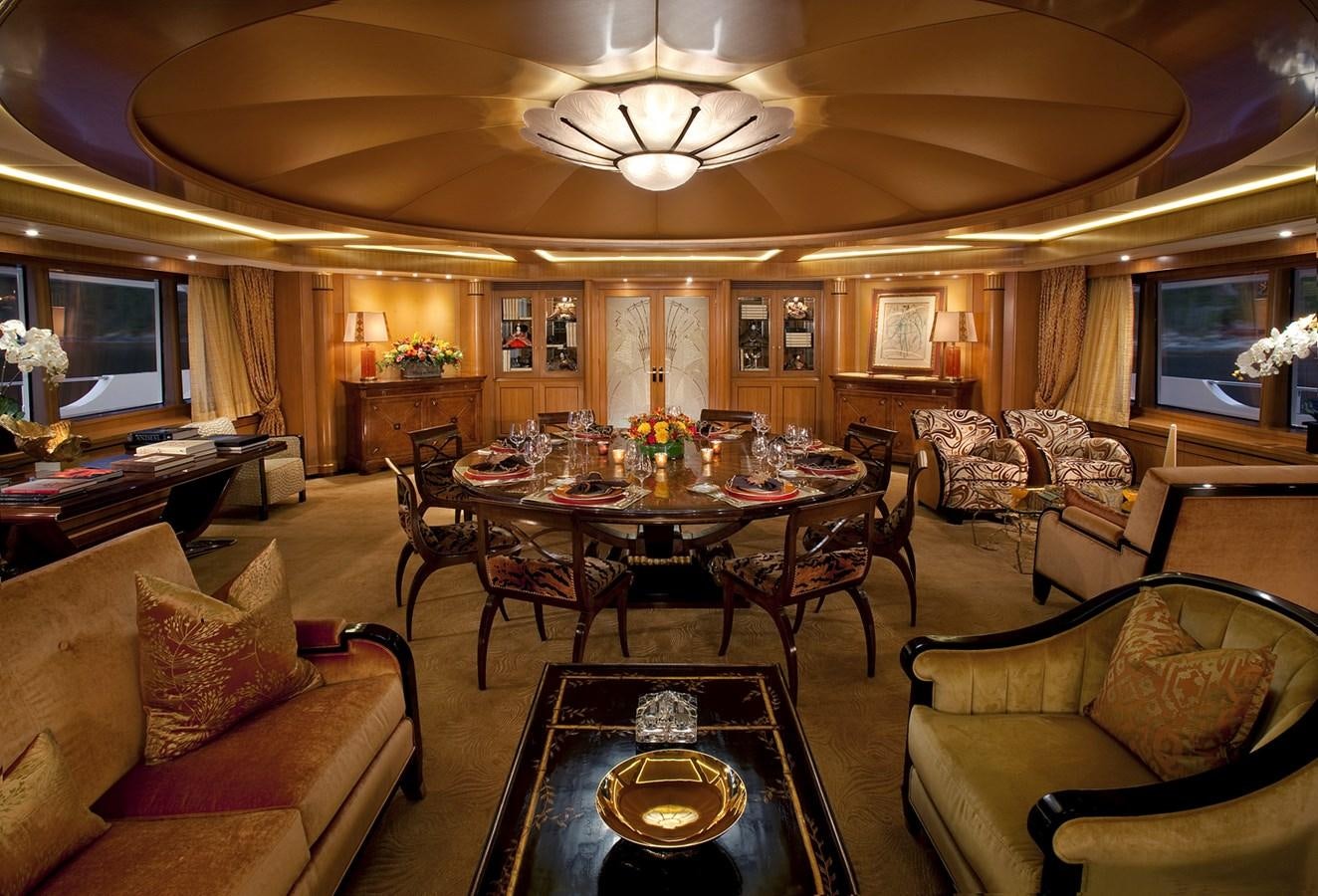 a living room with a table and chairs aboard ATTESSA IV Yacht for Sale