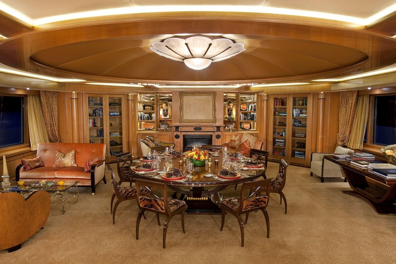 a large living room with a table and chairs aboard ATTESSA IV Yacht for Sale