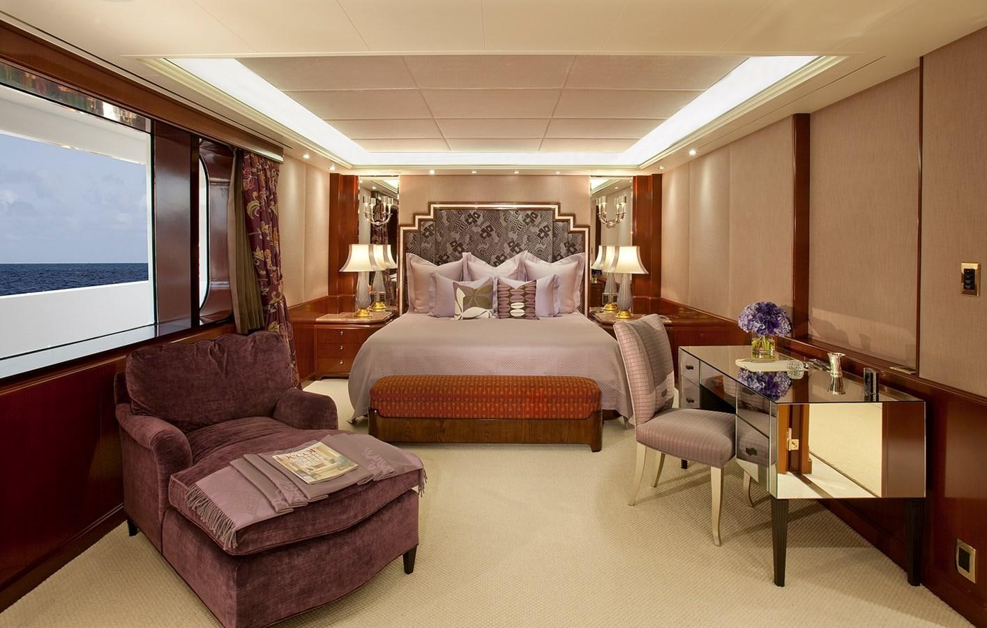 a hotel room with a bed and a desk aboard ATTESSA IV Yacht for Sale
