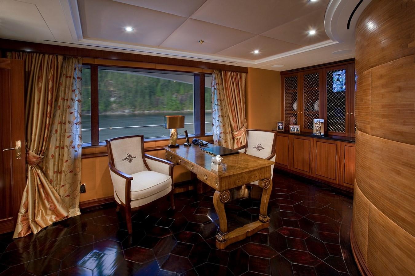 a room with a table and chairs aboard ATTESSA IV Yacht for Sale