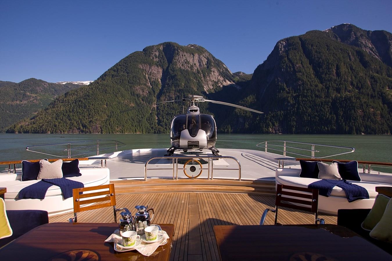 a table with chairs and a statue on it aboard ATTESSA IV Yacht for Sale