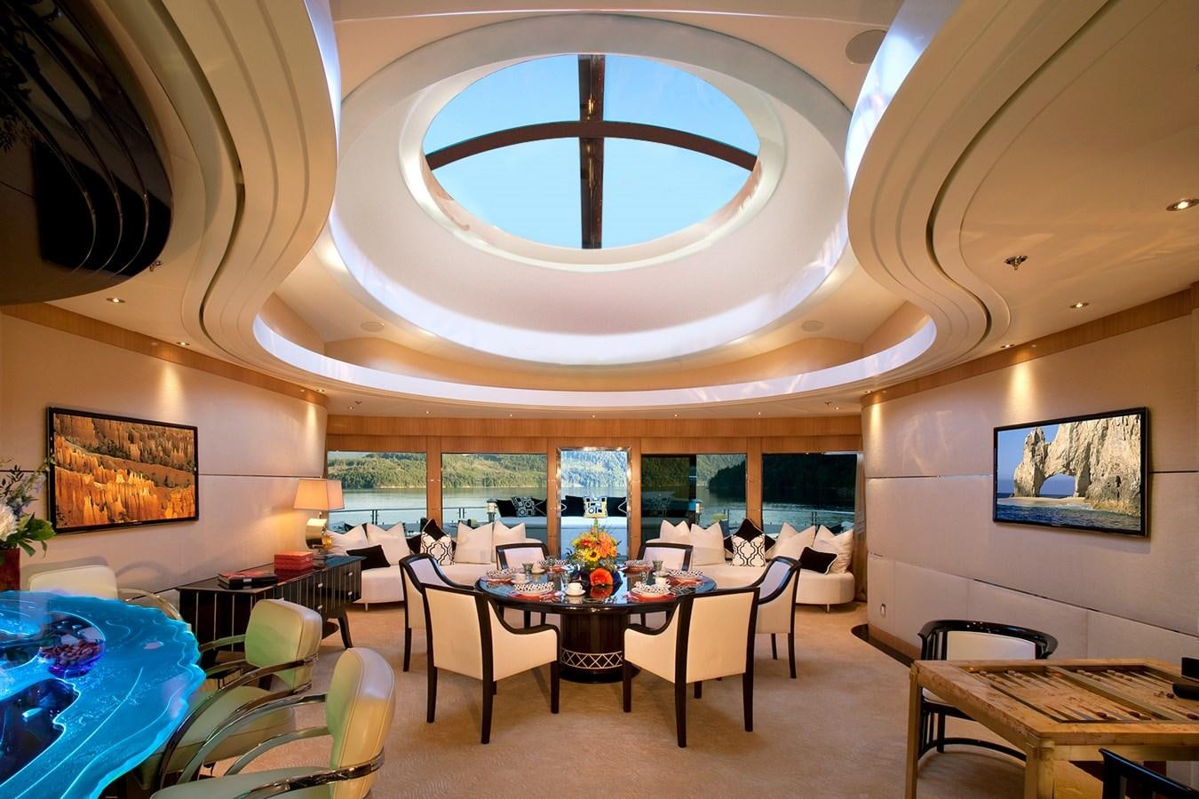 a room with tables and chairs aboard ATTESSA IV Yacht for Sale