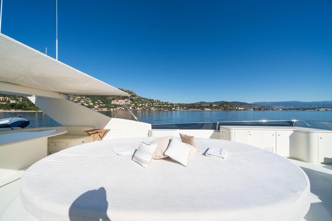 a white building with a roof and a view of the water aboard BEIJA FLORE Yacht for Sale