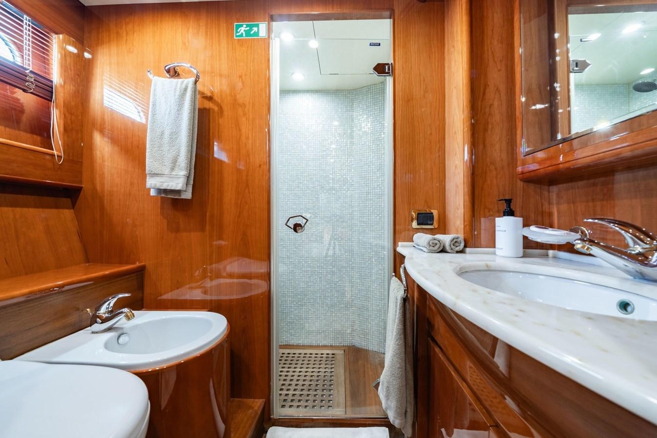 a bathroom with a shower sink and a bathtub aboard BEIJA FLORE Yacht for Sale