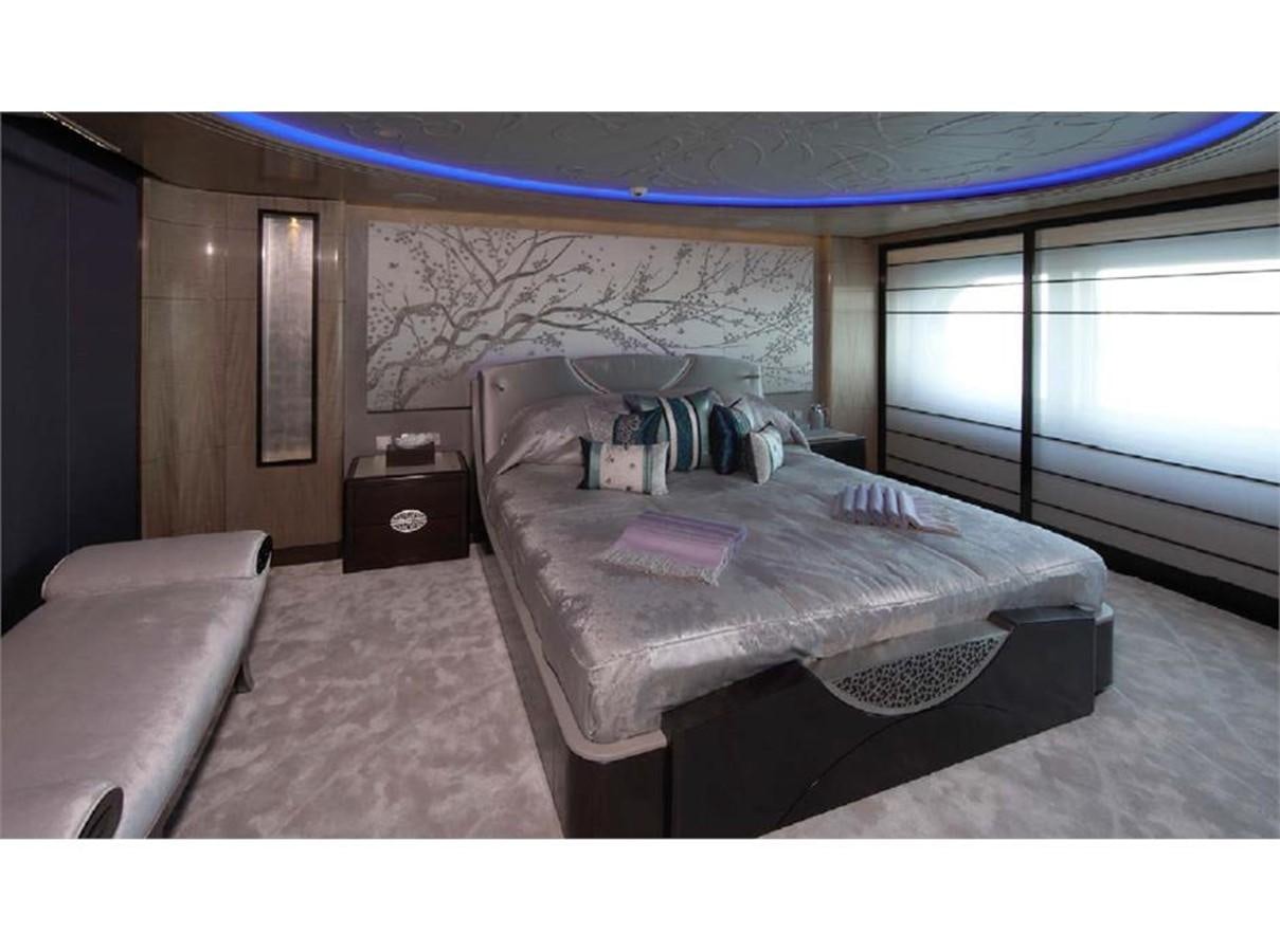 a bedroom with a bed and a window aboard AMARYLLIS Yacht for Sale