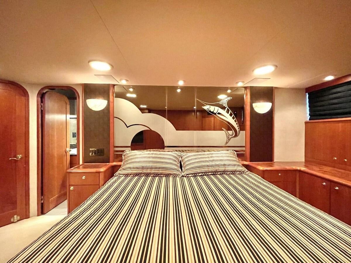 a bedroom with a bed and a bunk bed aboard AFTER MIDNIGHT Yacht for Sale