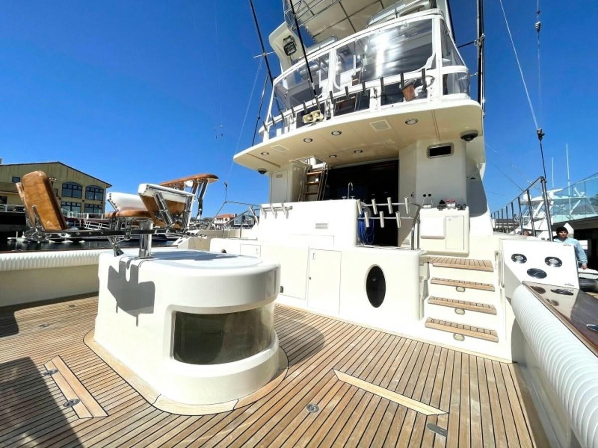 a large white boat on a wooden deck aboard AFTER MIDNIGHT Yacht for Sale