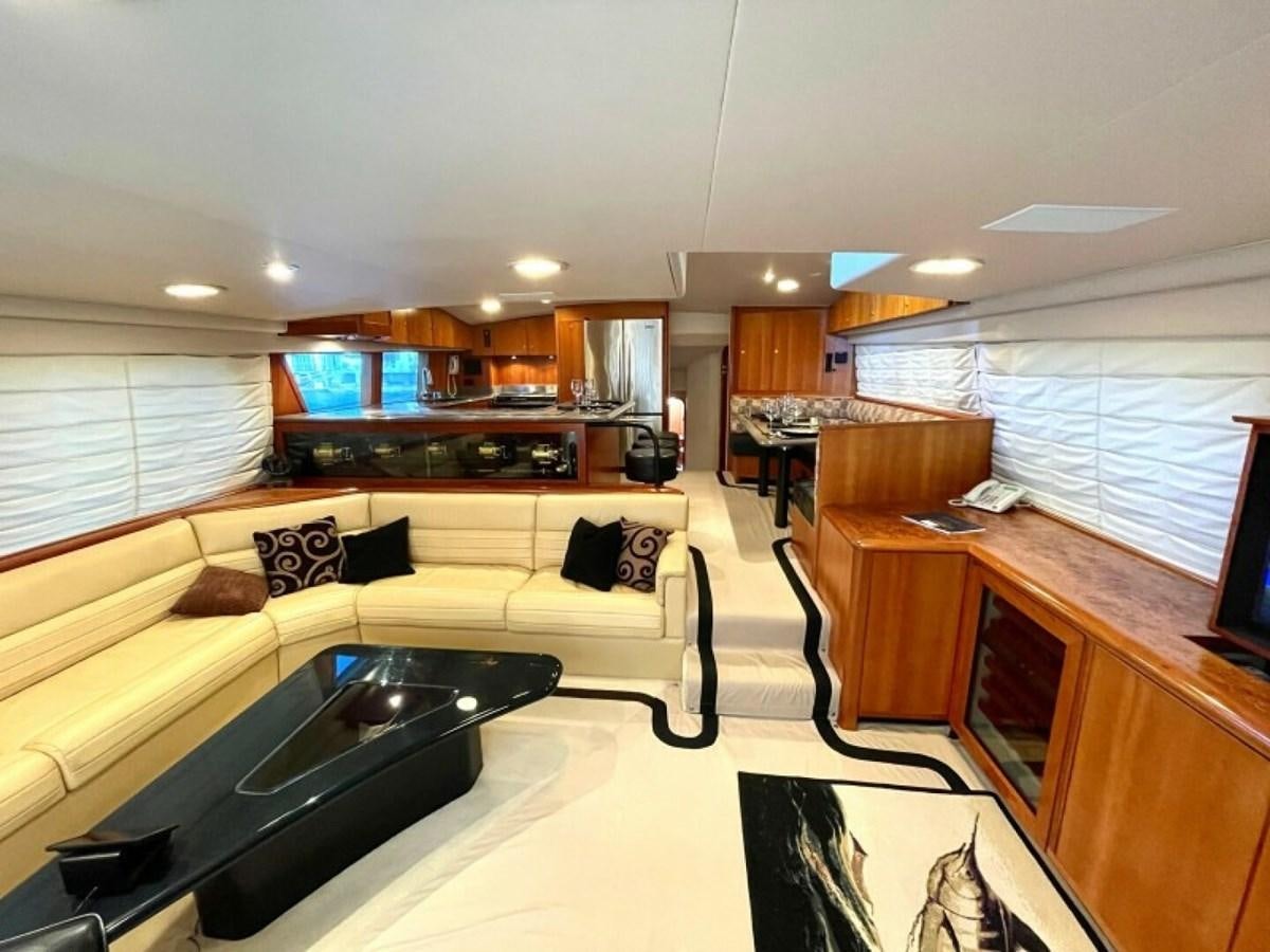a living room with a couch and a table aboard AFTER MIDNIGHT Yacht for Sale