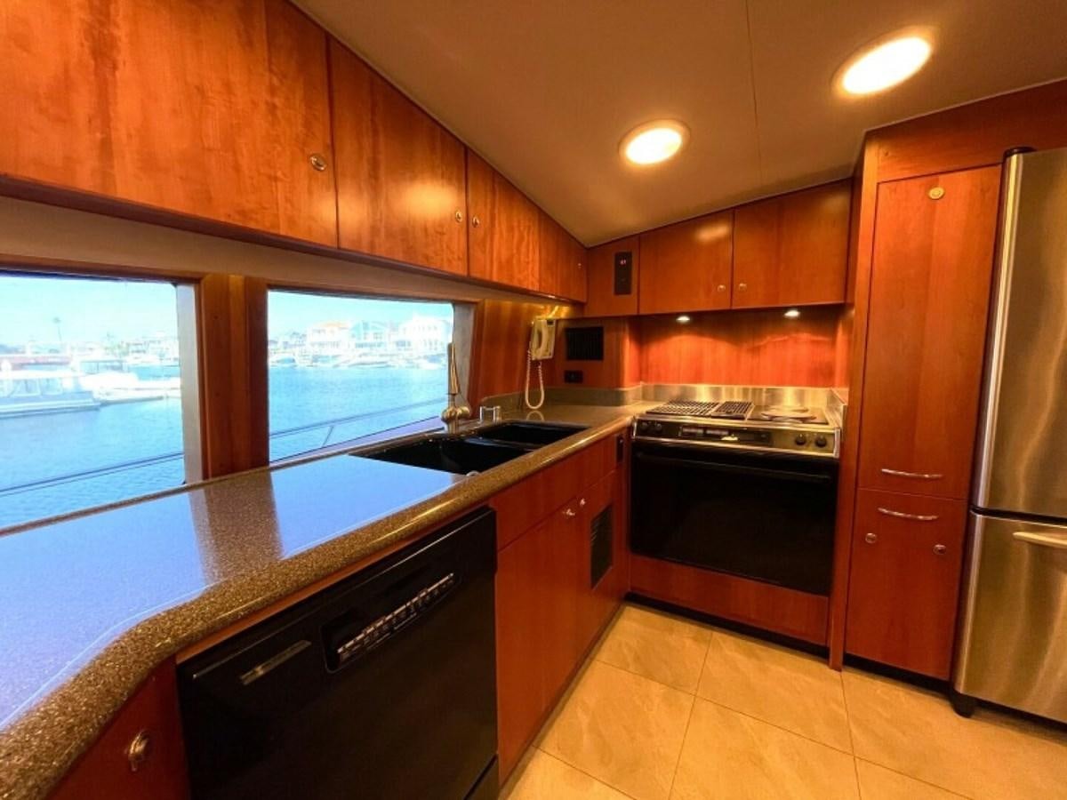 a kitchen with wooden cabinets aboard AFTER MIDNIGHT Yacht for Sale
