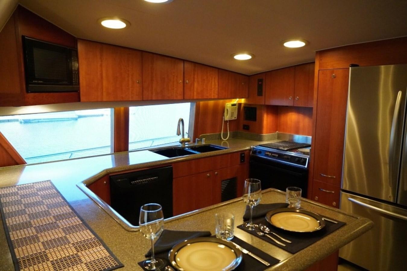 a kitchen with a large island aboard AFTER MIDNIGHT Yacht for Sale