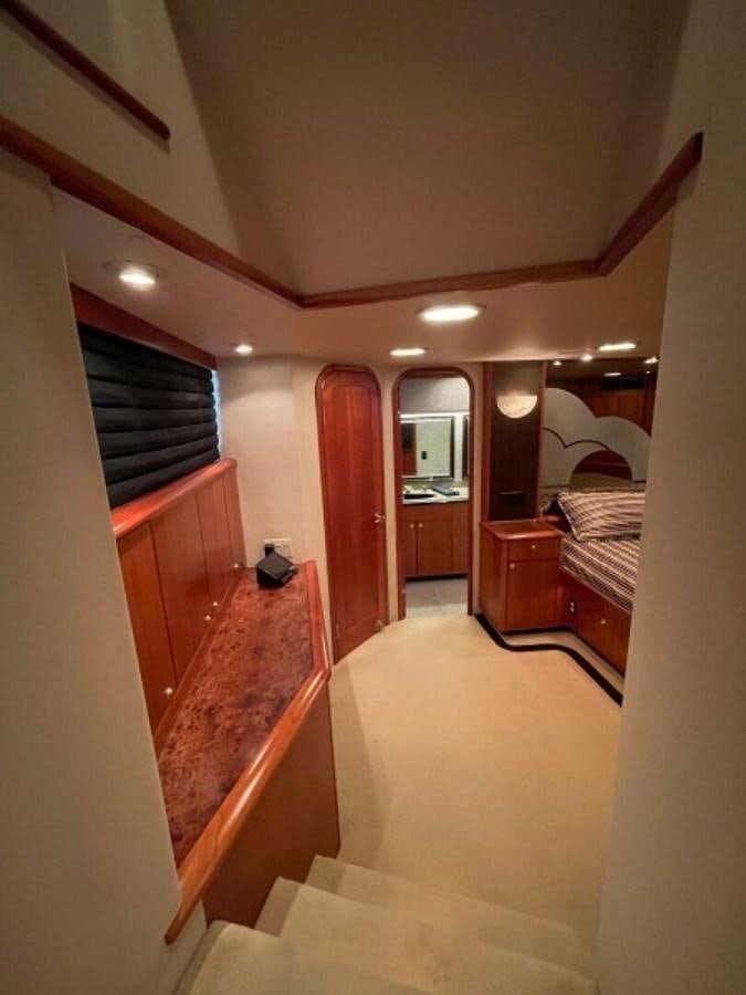 a room with a bed and a desk aboard AFTER MIDNIGHT Yacht for Sale