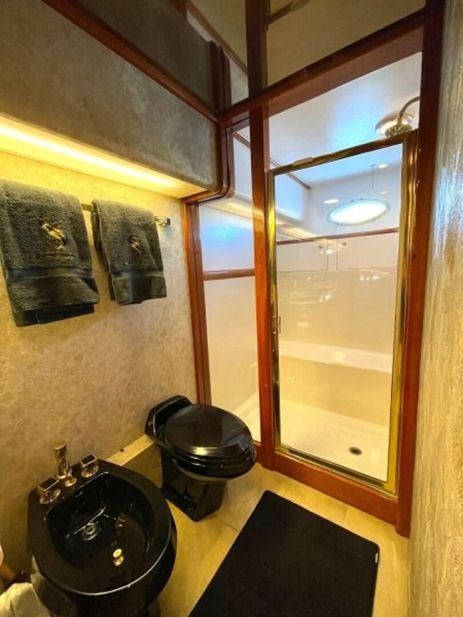 a bathroom with a large mirror aboard AFTER MIDNIGHT Yacht for Sale