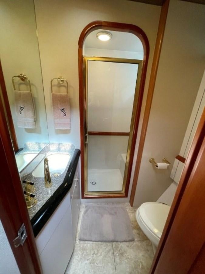 a bathroom with a glass shower aboard AFTER MIDNIGHT Yacht for Sale