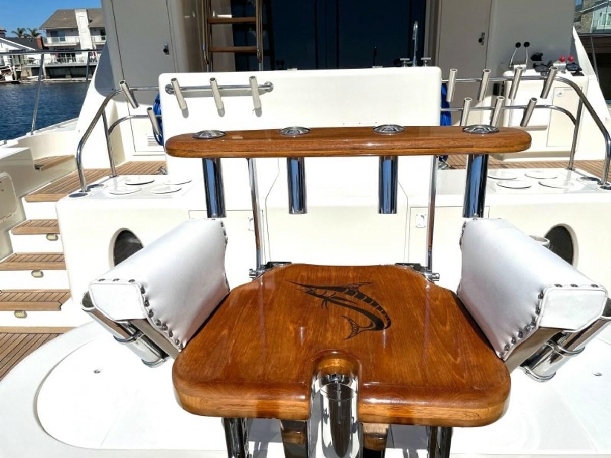 a wooden table with a chair aboard AFTER MIDNIGHT Yacht for Sale