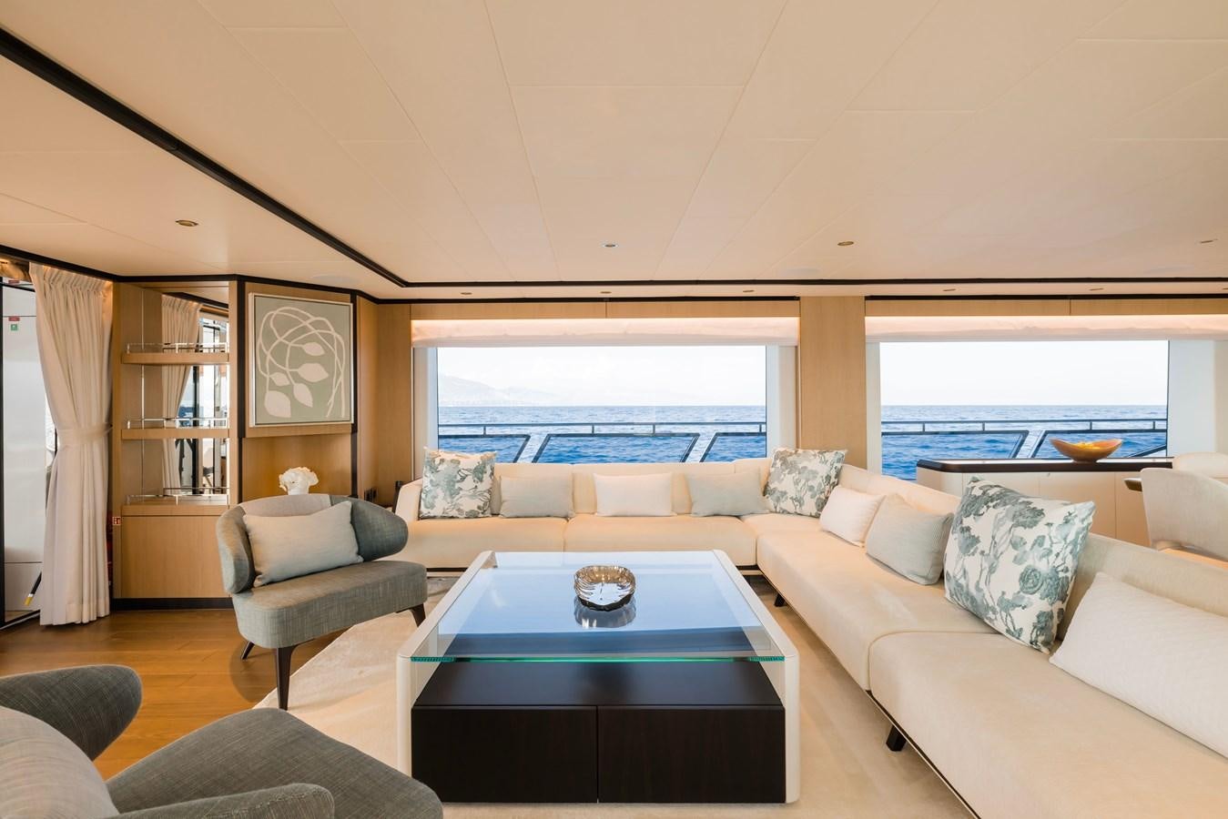 a living room with a large window aboard MAJESTY 111 Yacht for Sale