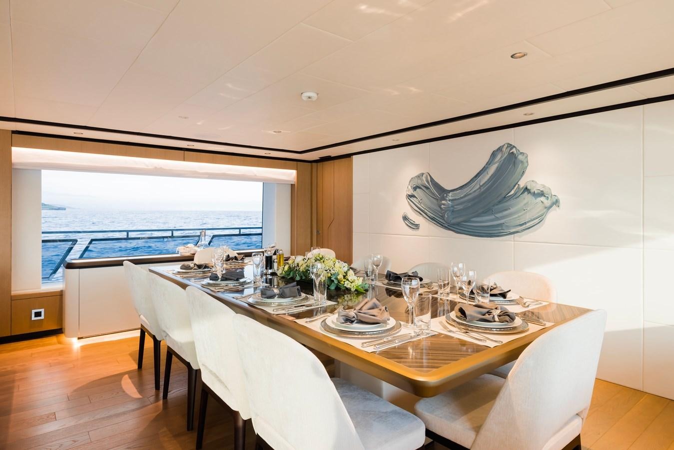 a dining room with a large fish tank aboard MAJESTY 111 Yacht for Sale
