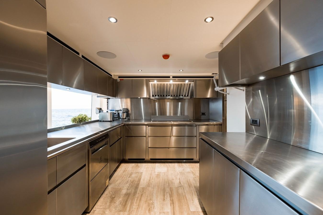 a kitchen with stainless steel appliances aboard MAJESTY 111 Yacht for Sale