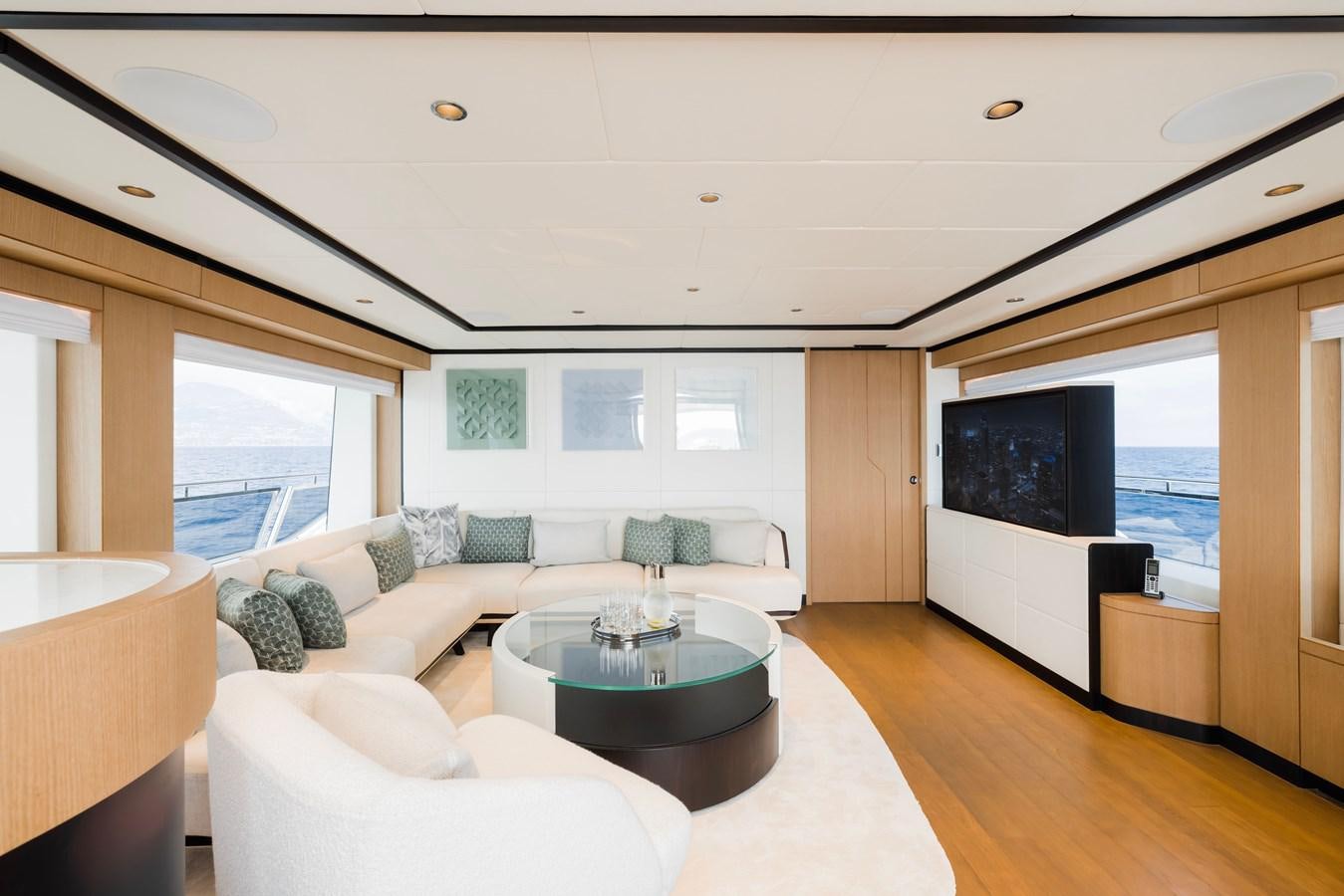 a living room with a large screen aboard MAJESTY 111 Yacht for Sale