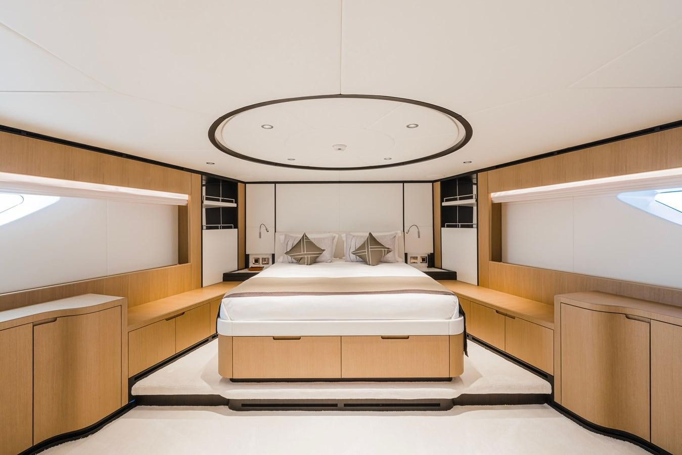 a room with a bed and a round mirror aboard MAJESTY 111 Yacht for Sale